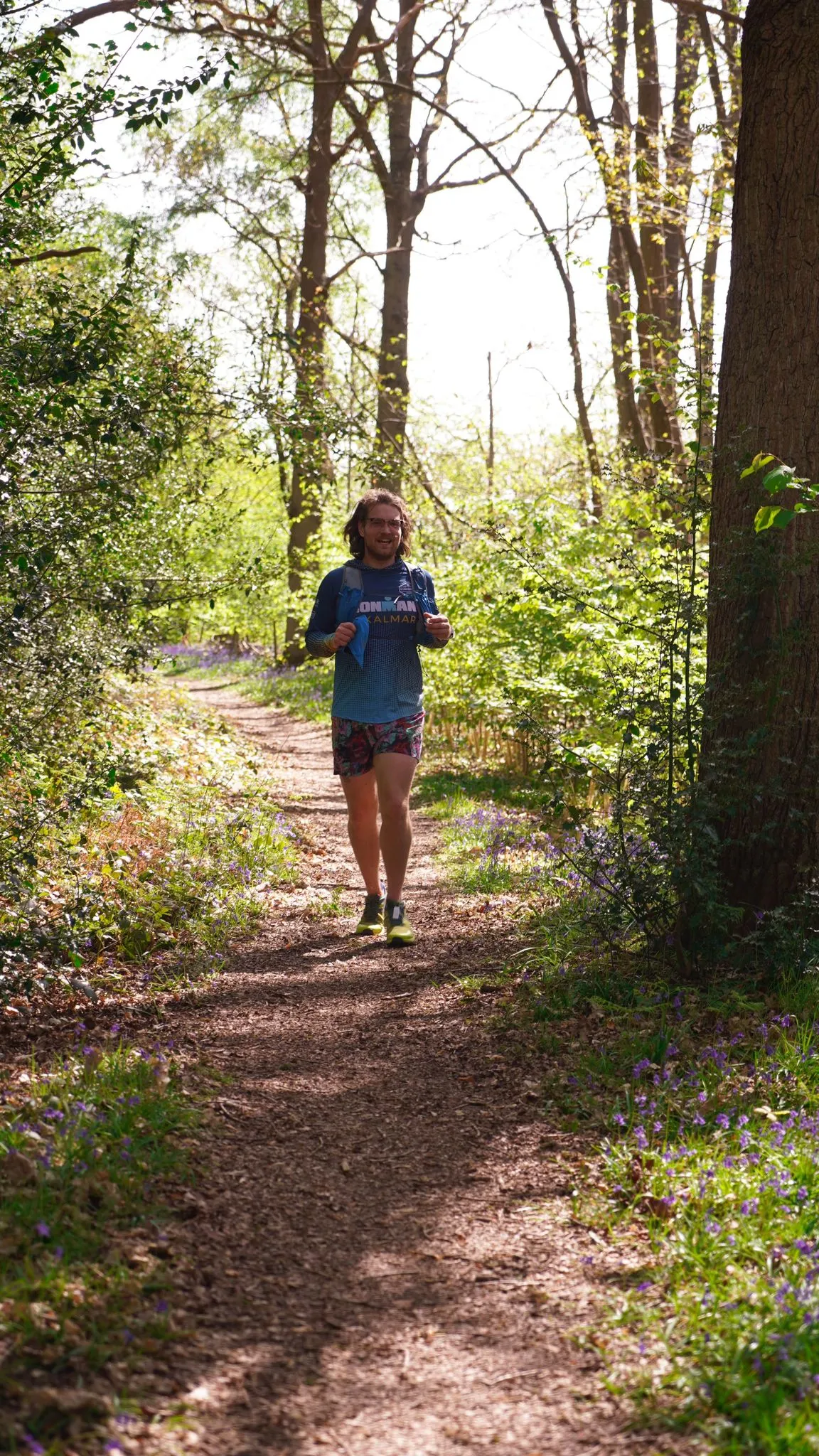A runner on the bluebell woodland trail at Backyard Egg