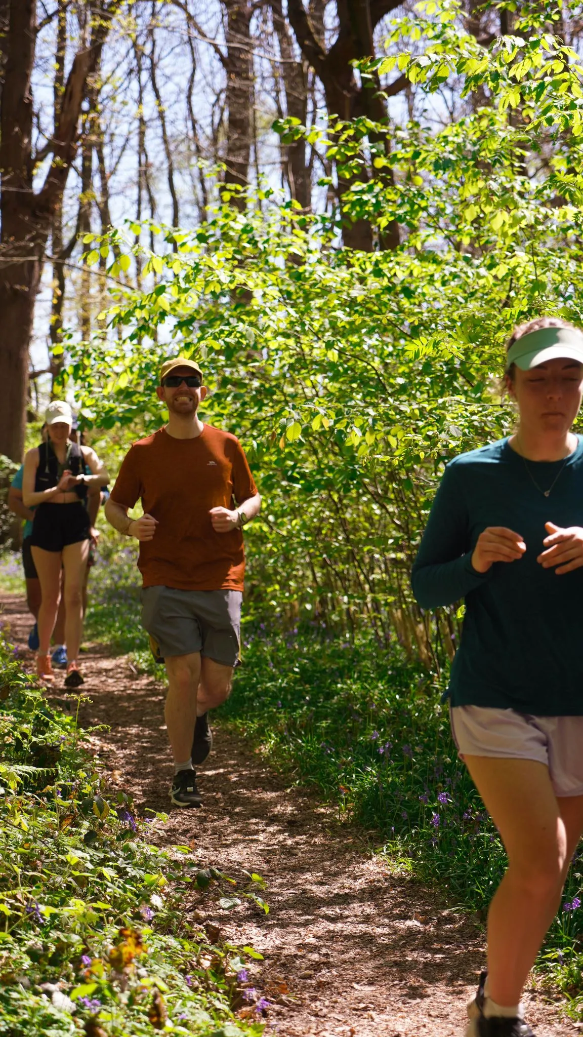 A runner on the bluebell woodland trail at Backyard Egg