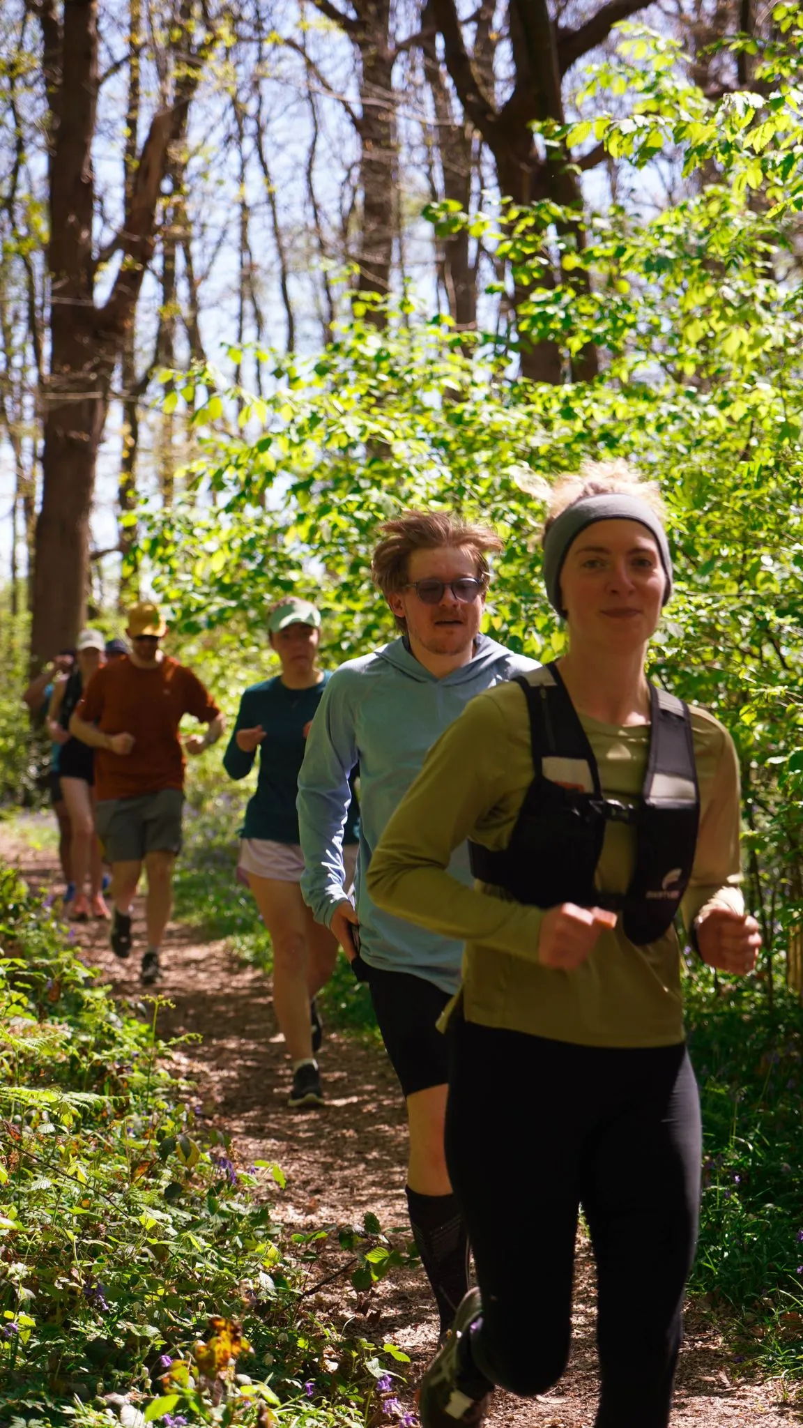 A runner on the bluebell woodland trail at Backyard Egg