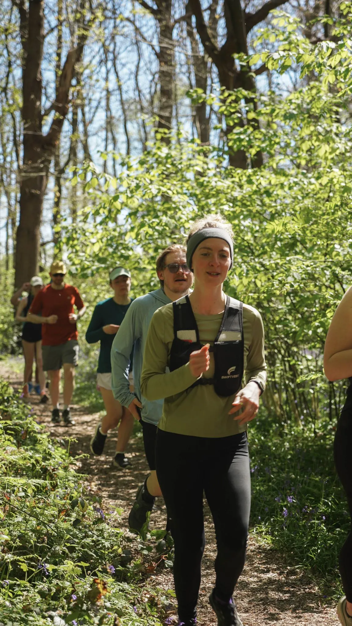 A runner on the bluebell woodland trail at Backyard Egg