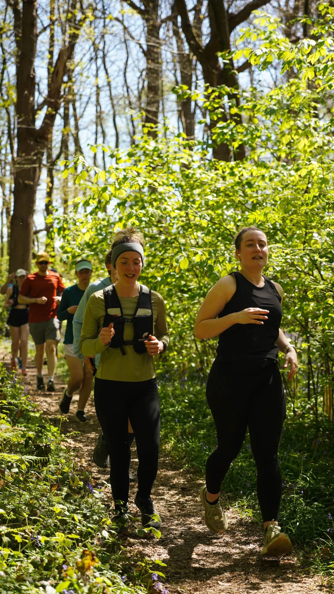 A runner on the bluebell woodland trail at Backyard Egg