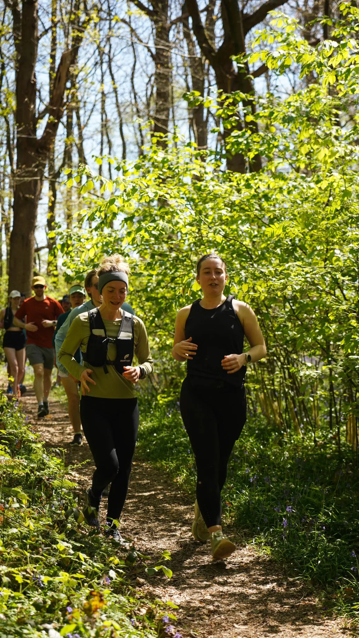 A runner on the bluebell woodland trail at Backyard Egg