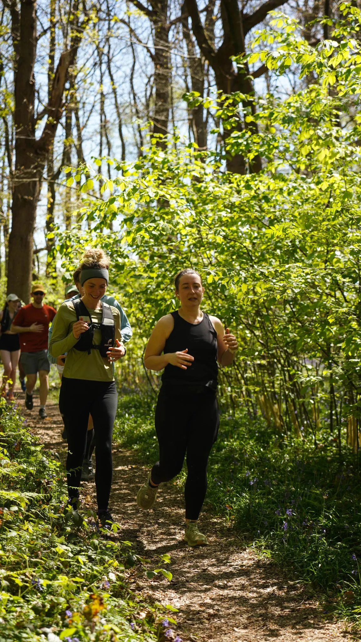 A runner on the bluebell woodland trail at Backyard Egg