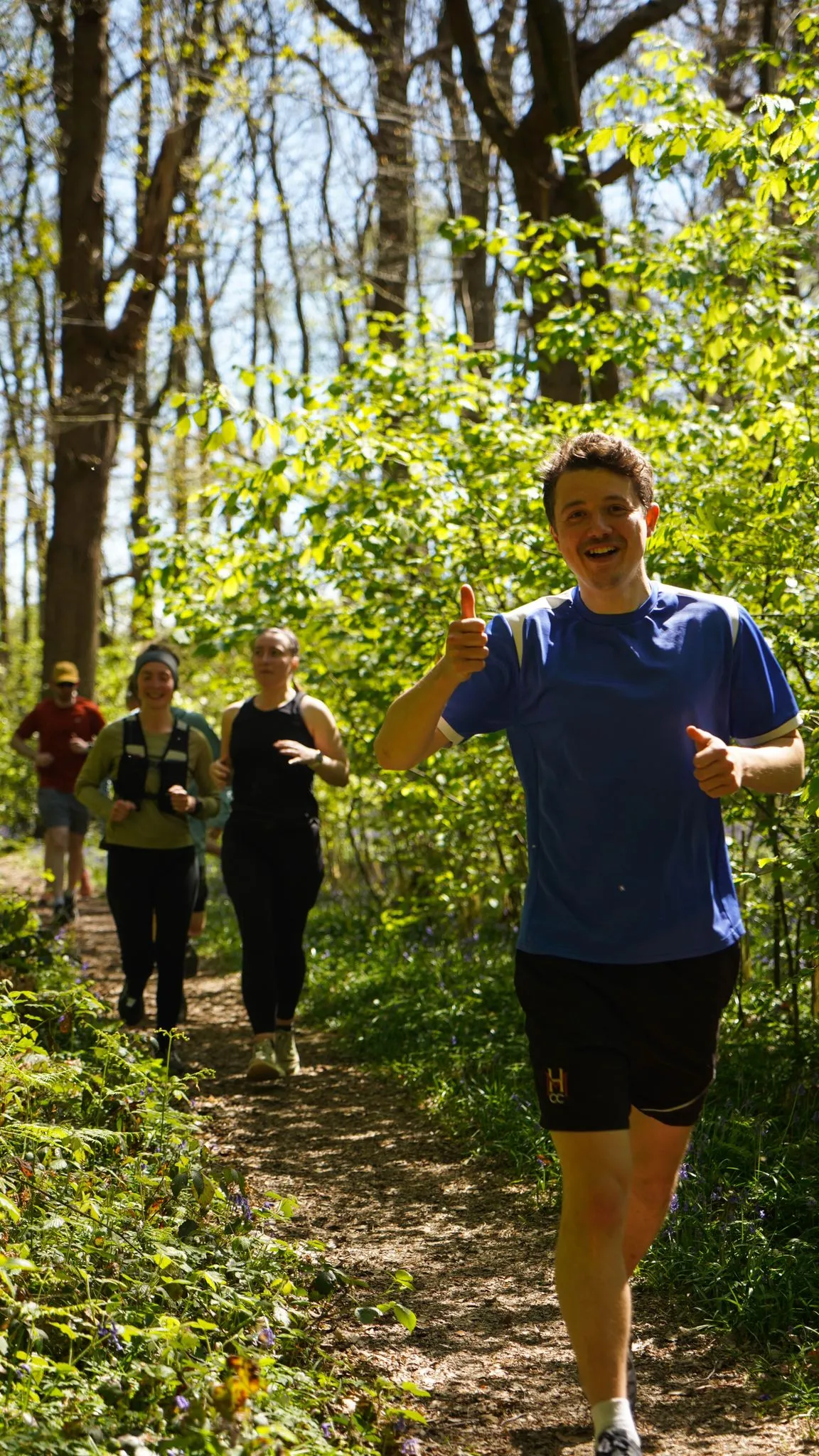 A runner on the bluebell woodland trail at Backyard Egg
