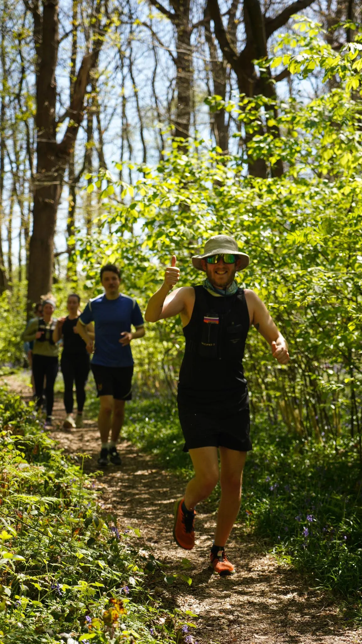 A runner on the bluebell woodland trail at Backyard Egg