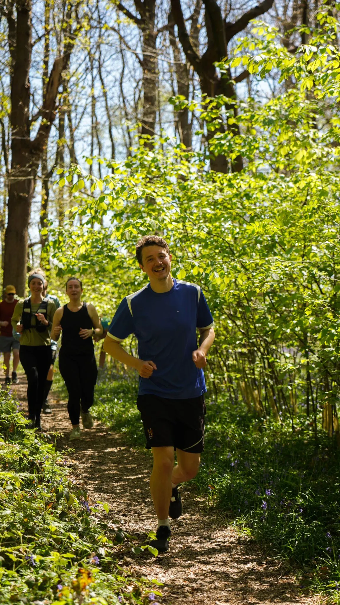 A runner on the bluebell woodland trail at Backyard Egg
