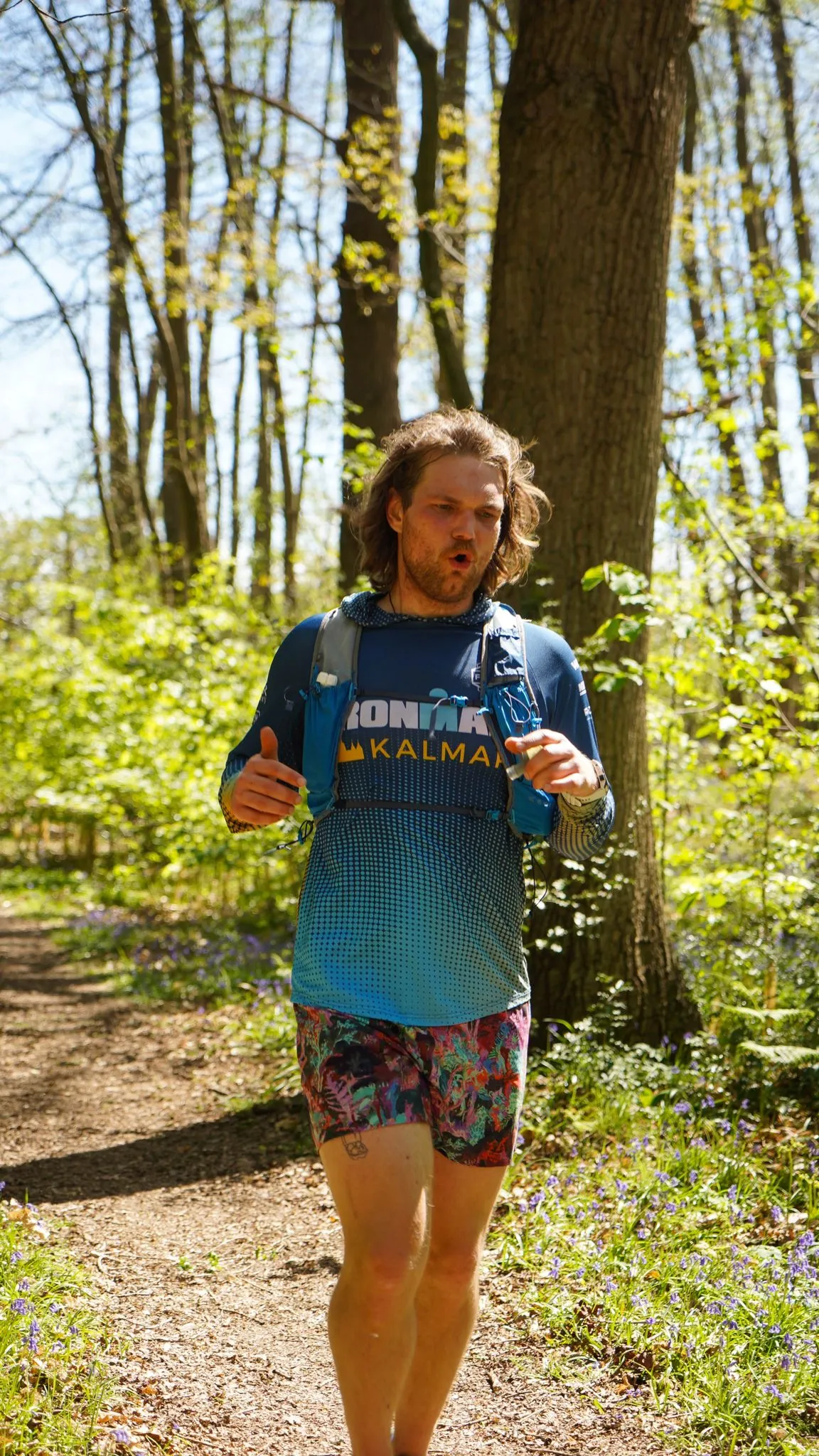 A runner on the bluebell woodland trail at Backyard Egg
