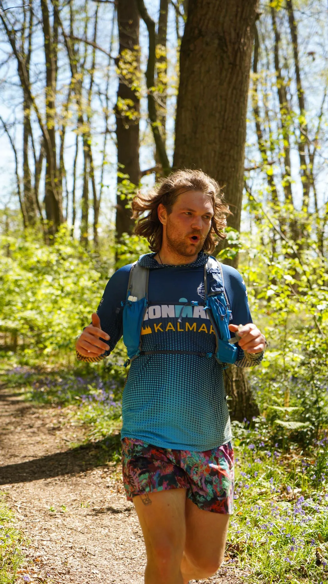 A runner on the bluebell woodland trail at Backyard Egg