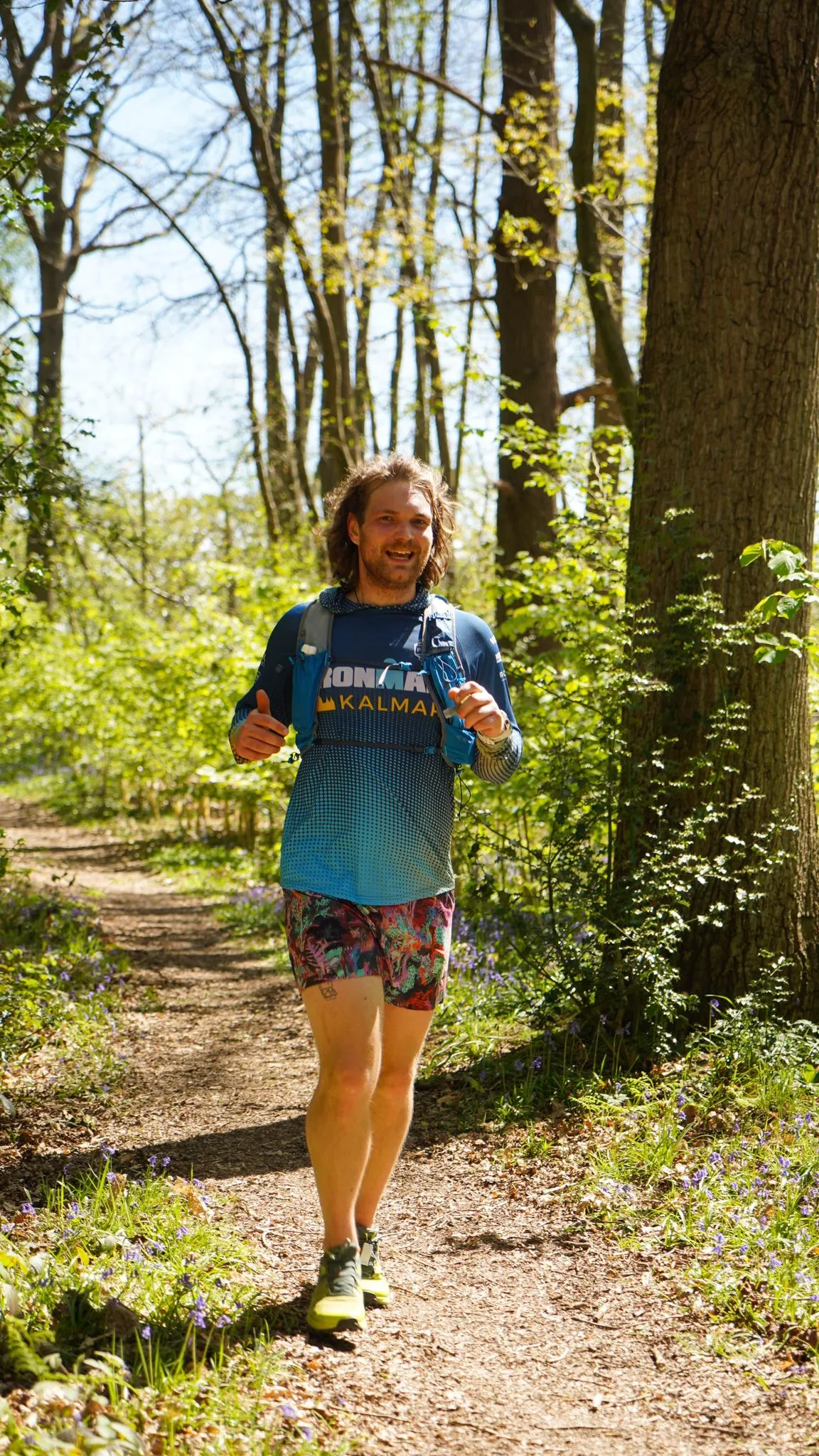A runner on the bluebell woodland trail at Backyard Egg