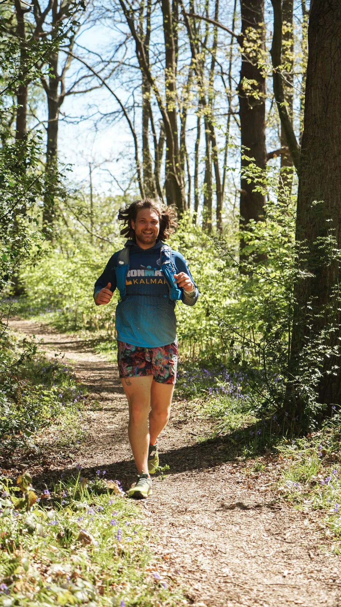 A runner on the bluebell woodland trail at Backyard Egg