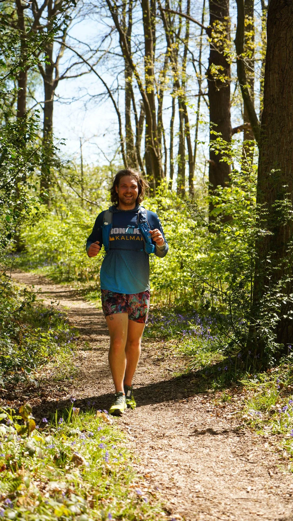 A runner on the bluebell woodland trail at Backyard Egg