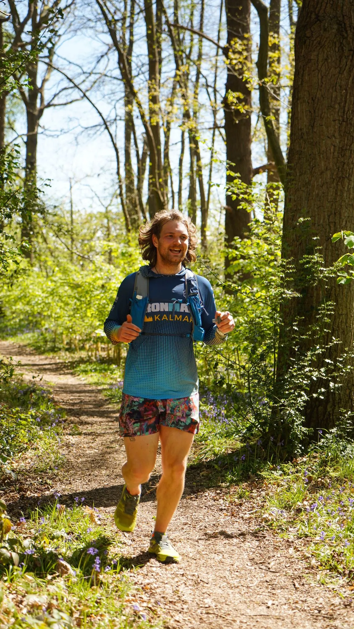 A runner on the bluebell woodland trail at Backyard Egg