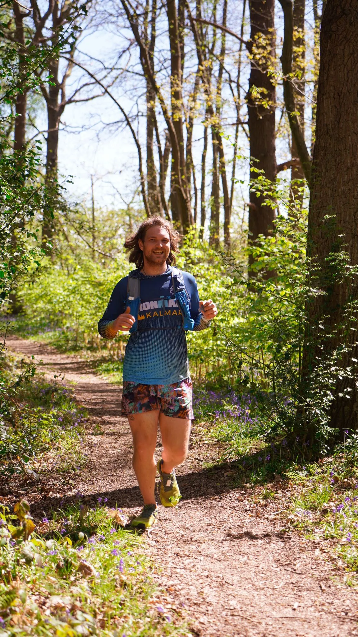 A runner on the bluebell woodland trail at Backyard Egg