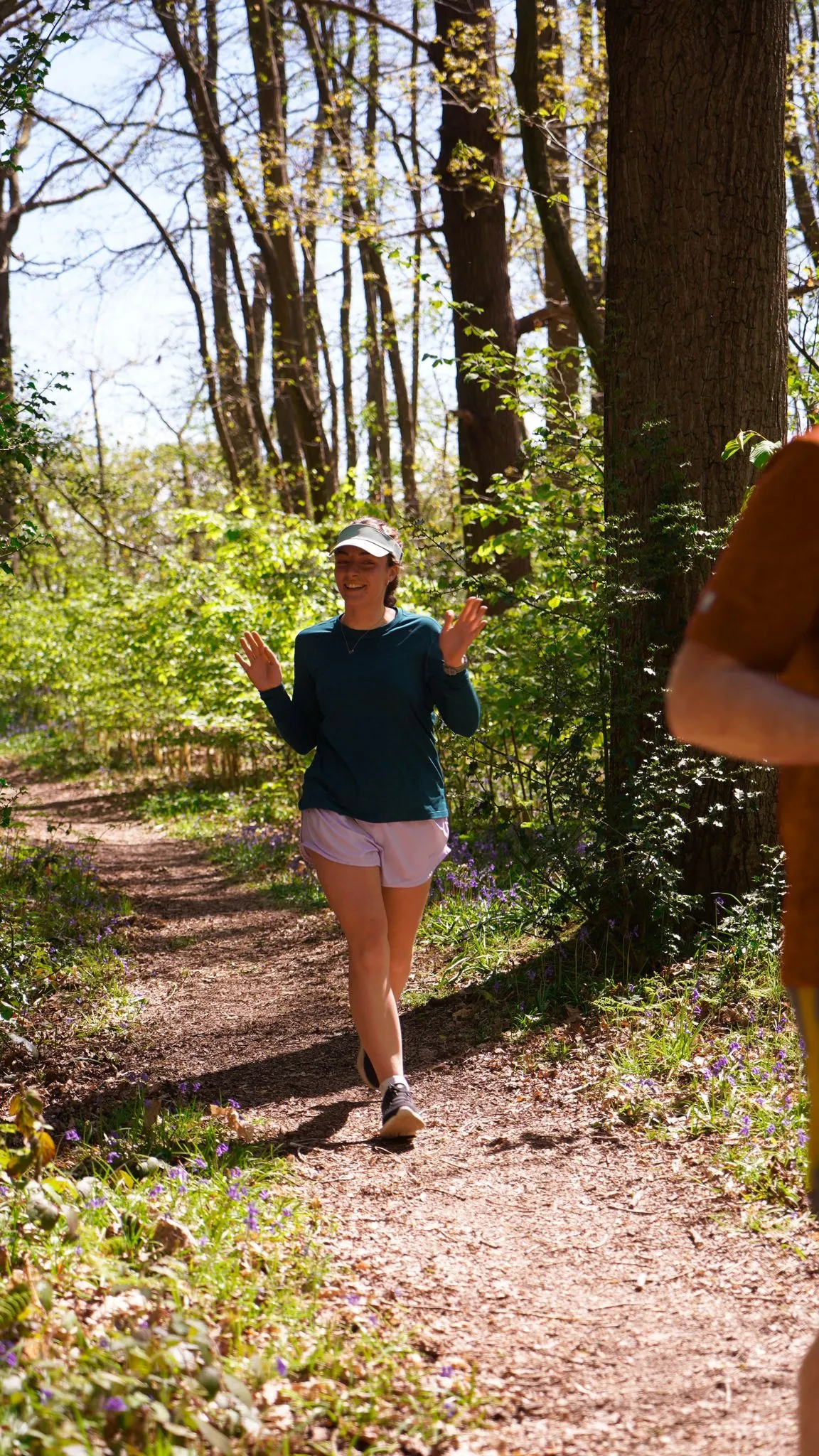 A runner on the bluebell woodland trail at Backyard Egg