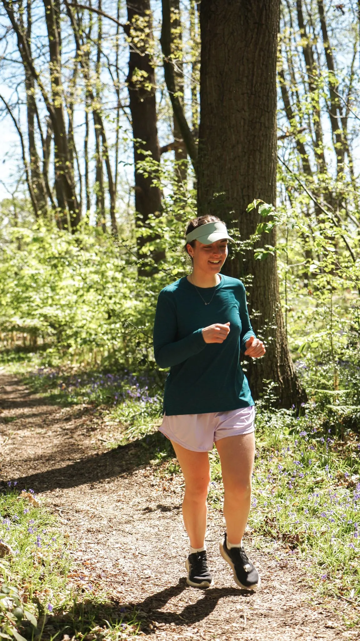 A runner on the bluebell woodland trail at Backyard Egg