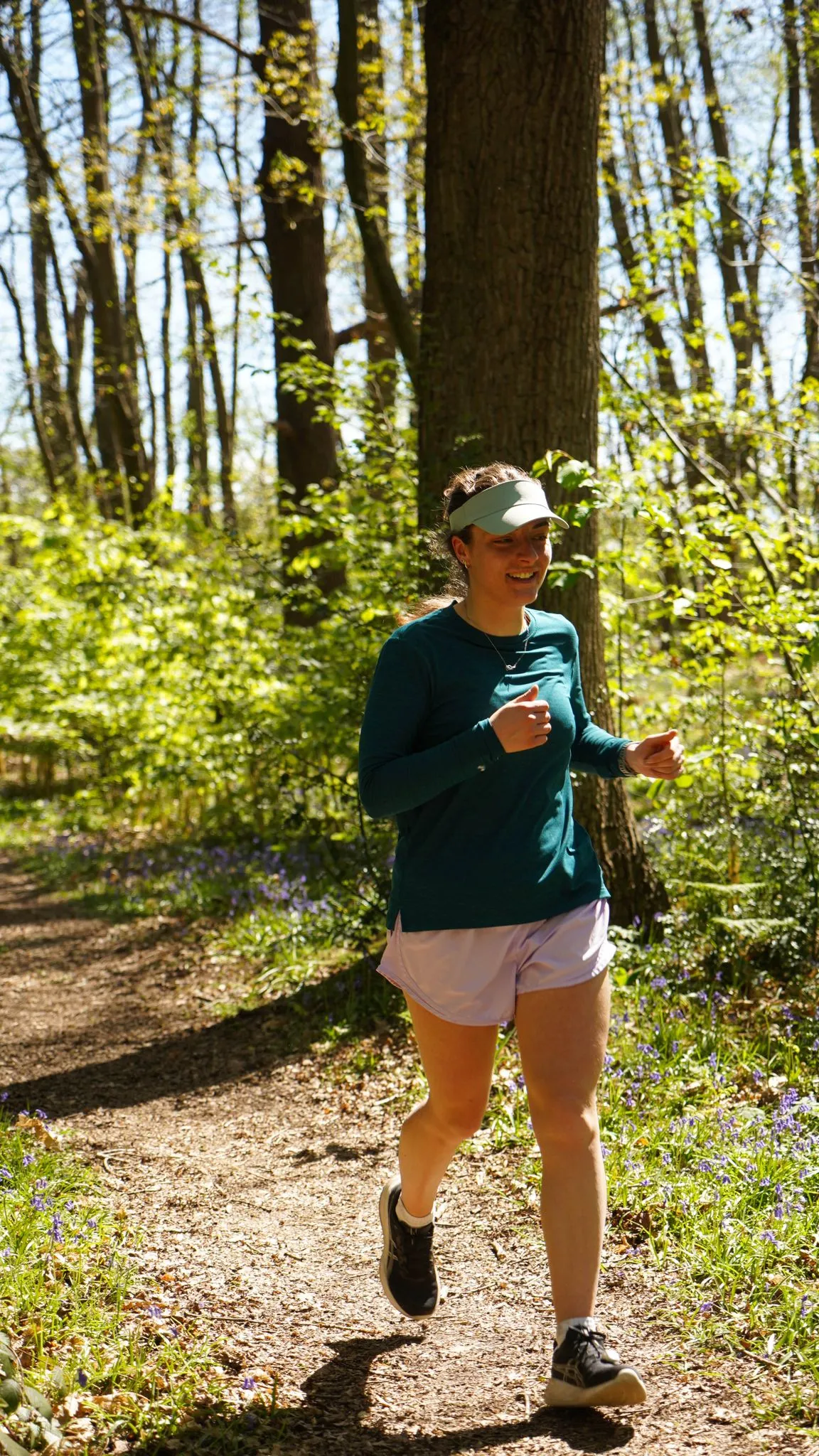 A runner on the bluebell woodland trail at Backyard Egg