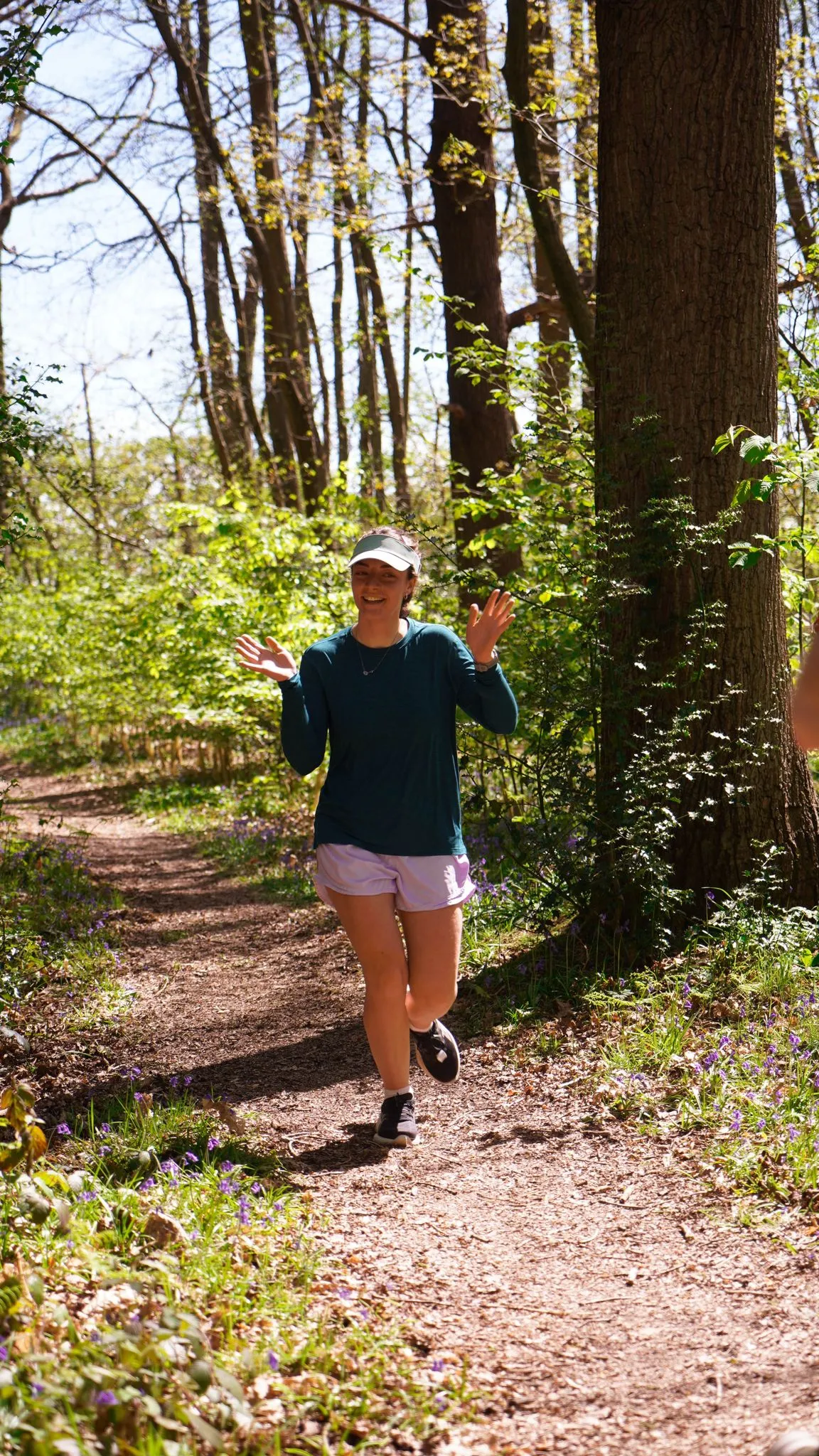 A runner on the bluebell woodland trail at Backyard Egg