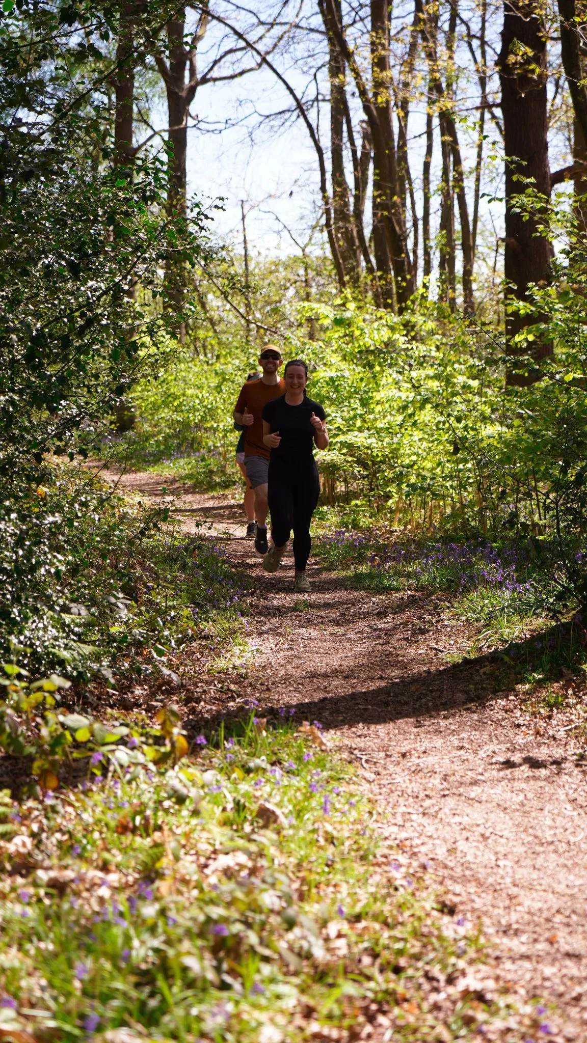 A runner on the bluebell woodland trail at Backyard Egg