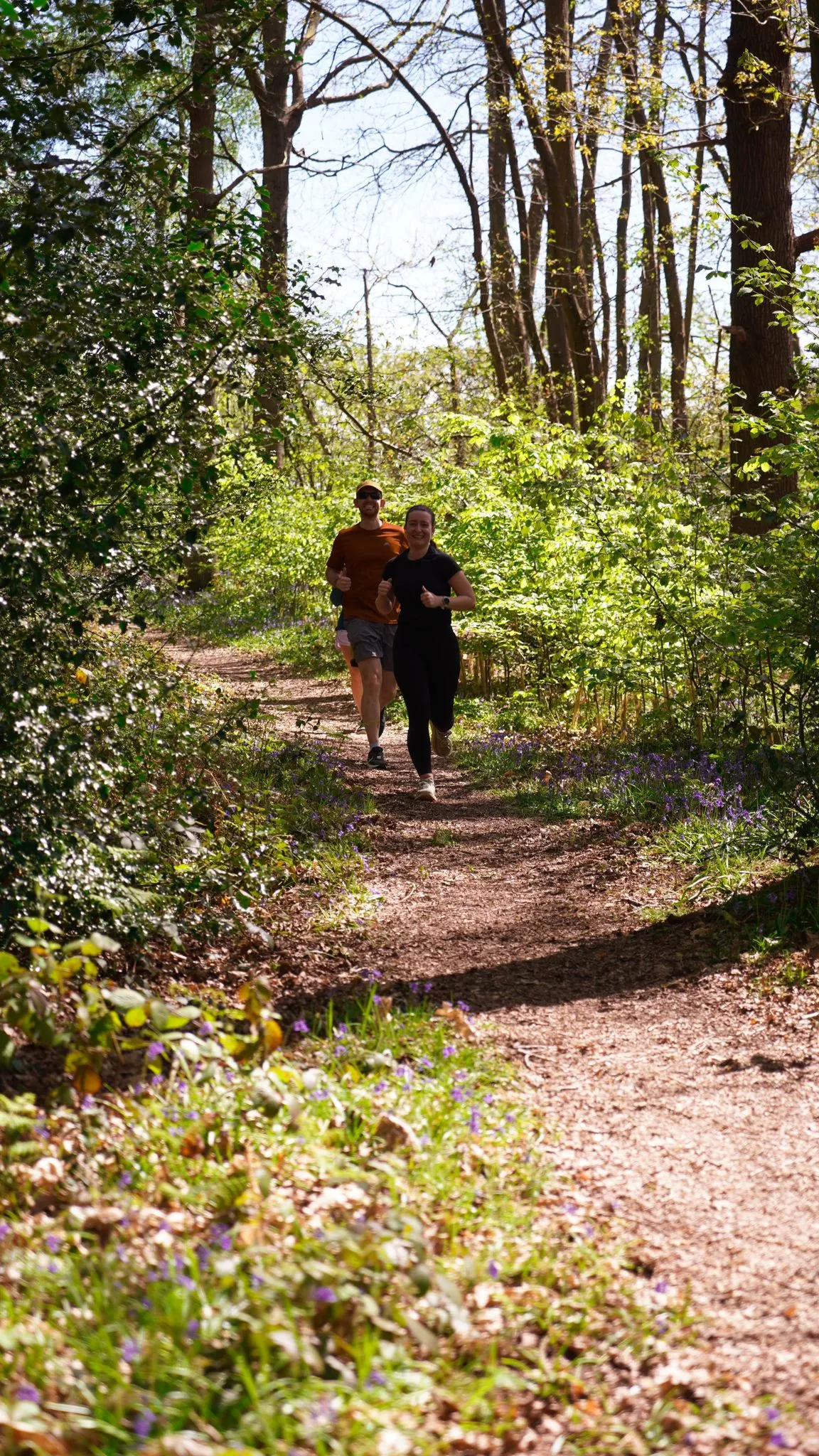 A runner on the bluebell woodland trail at Backyard Egg