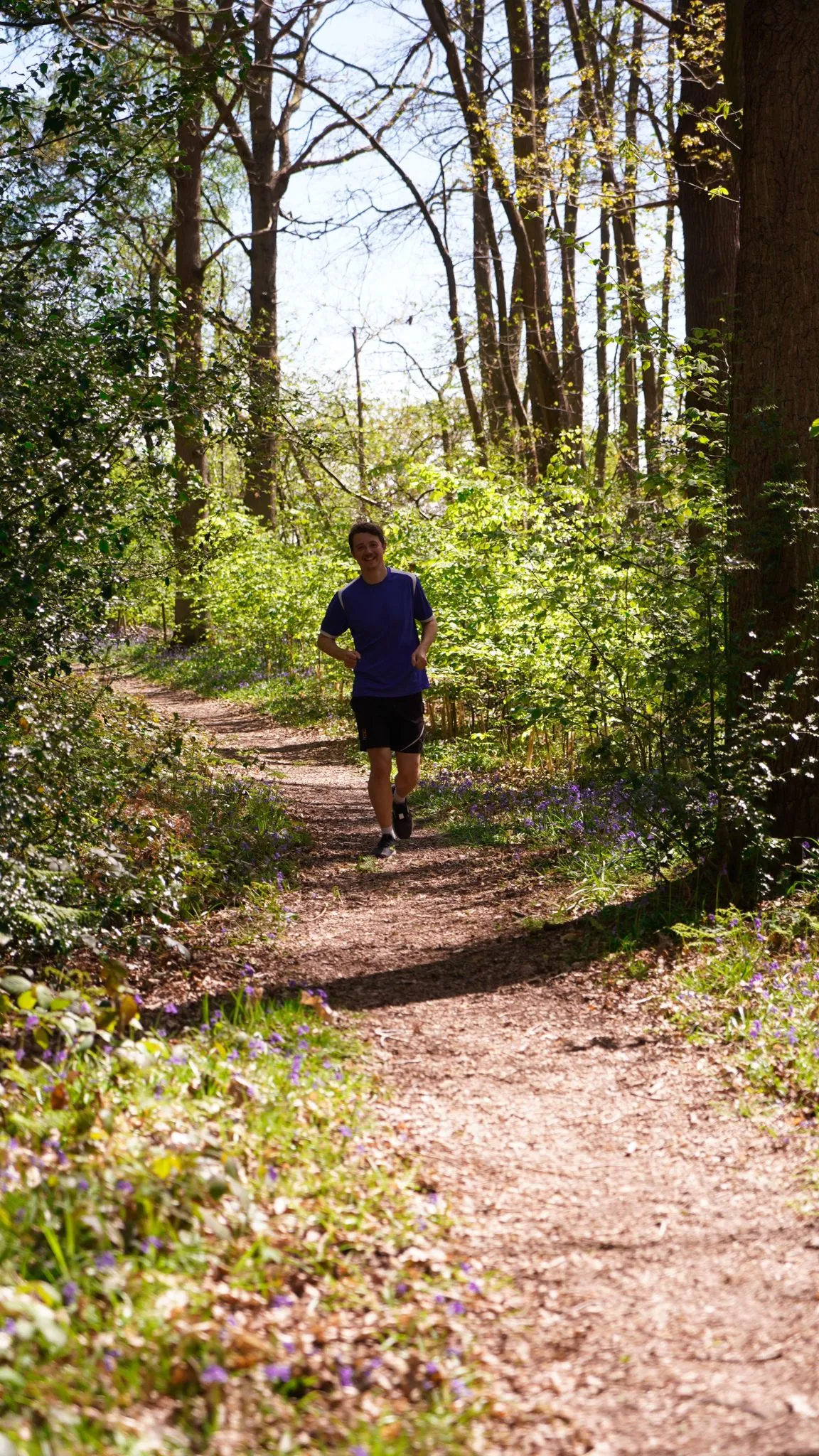 A runner on the bluebell woodland trail at Backyard Egg