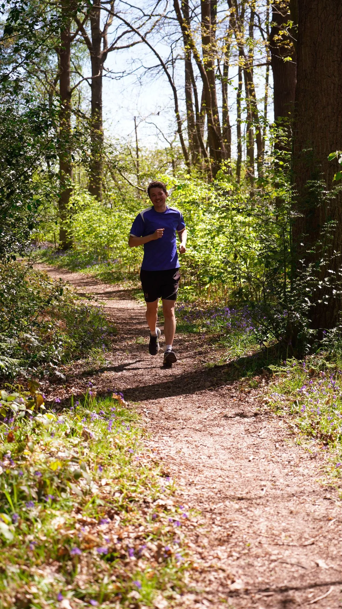 A runner on the bluebell woodland trail at Backyard Egg