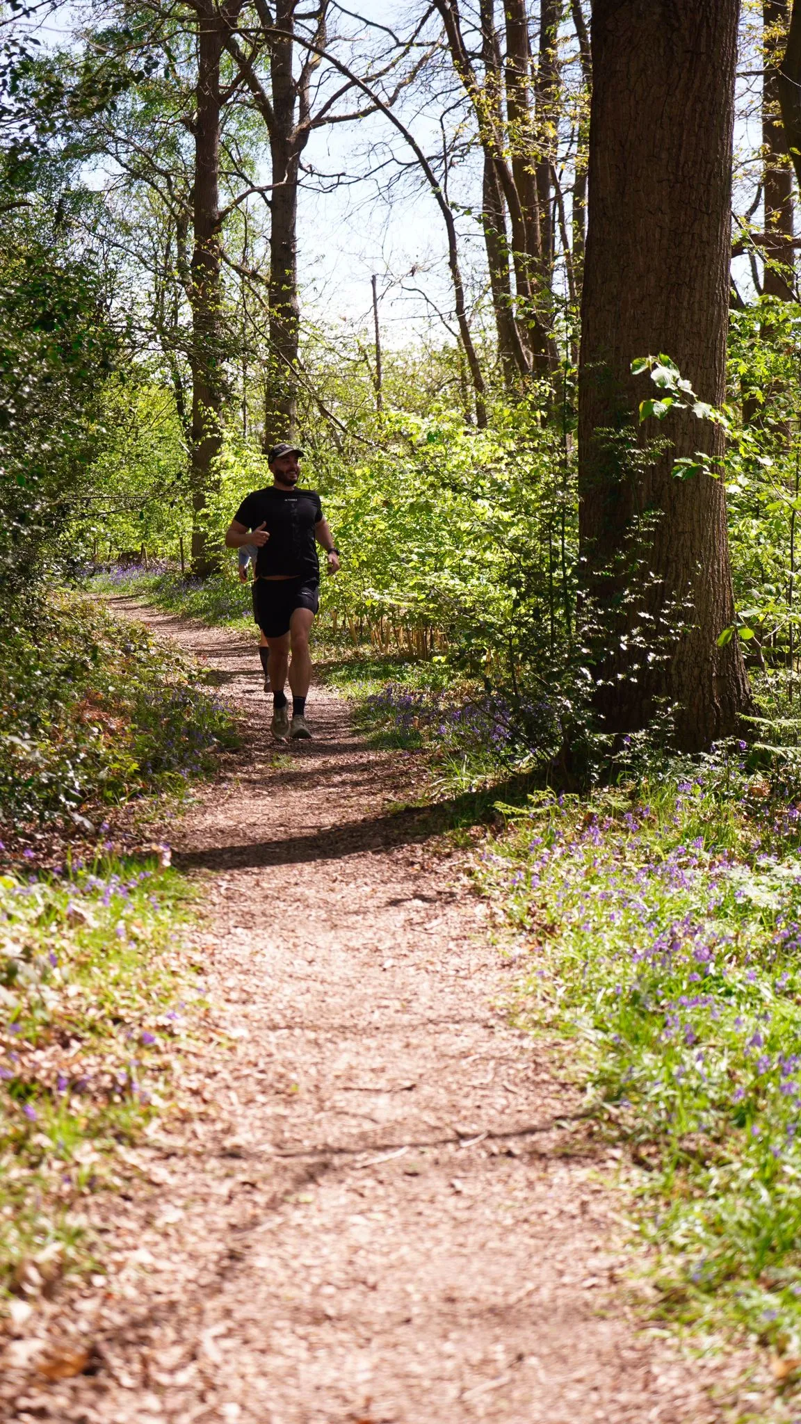 A runner on the bluebell woodland trail at Backyard Egg