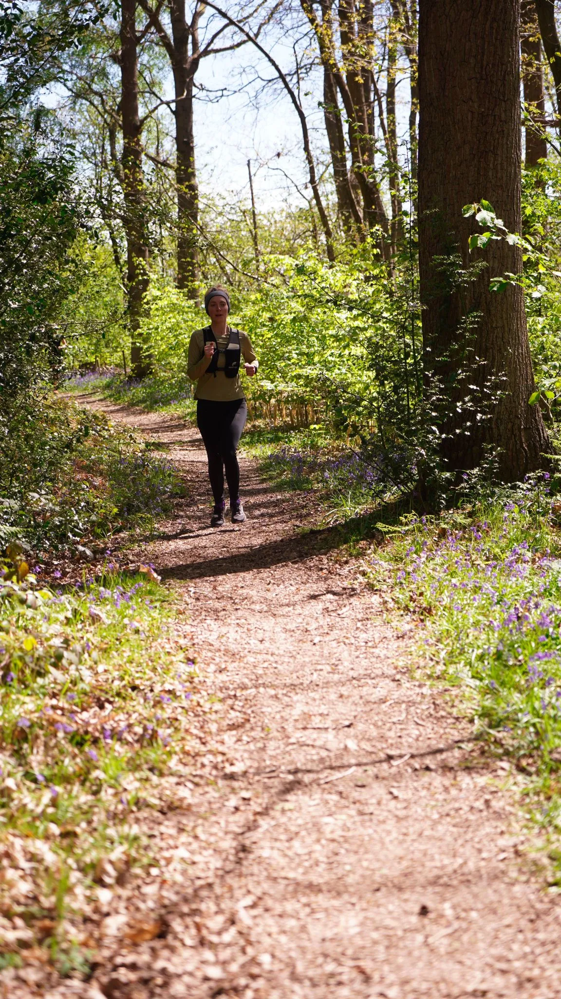 A runner on the bluebell woodland trail at Backyard Egg