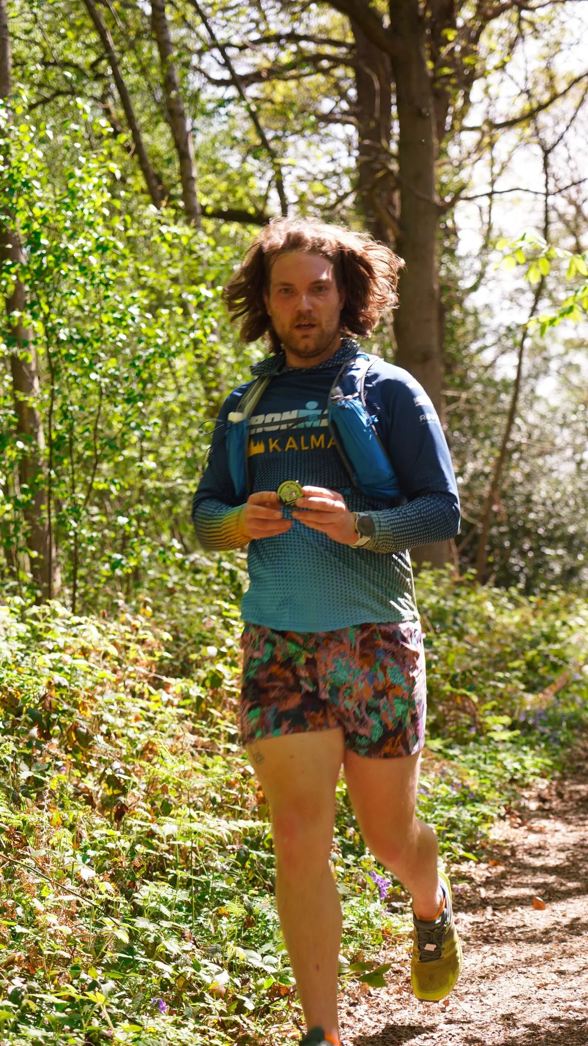 A runner on the bluebell woodland trail at Backyard Egg