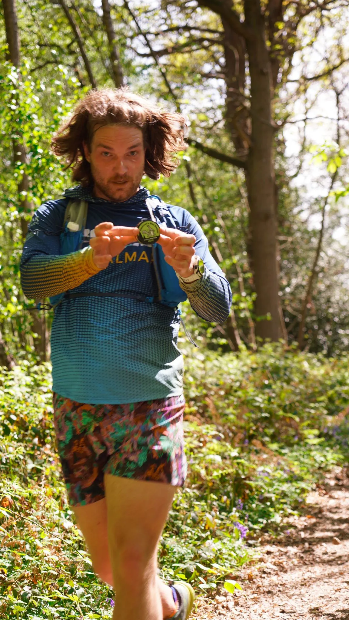 A runner on the bluebell woodland trail at Backyard Egg