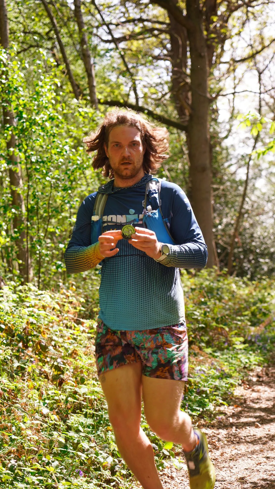 A runner on the bluebell woodland trail at Backyard Egg