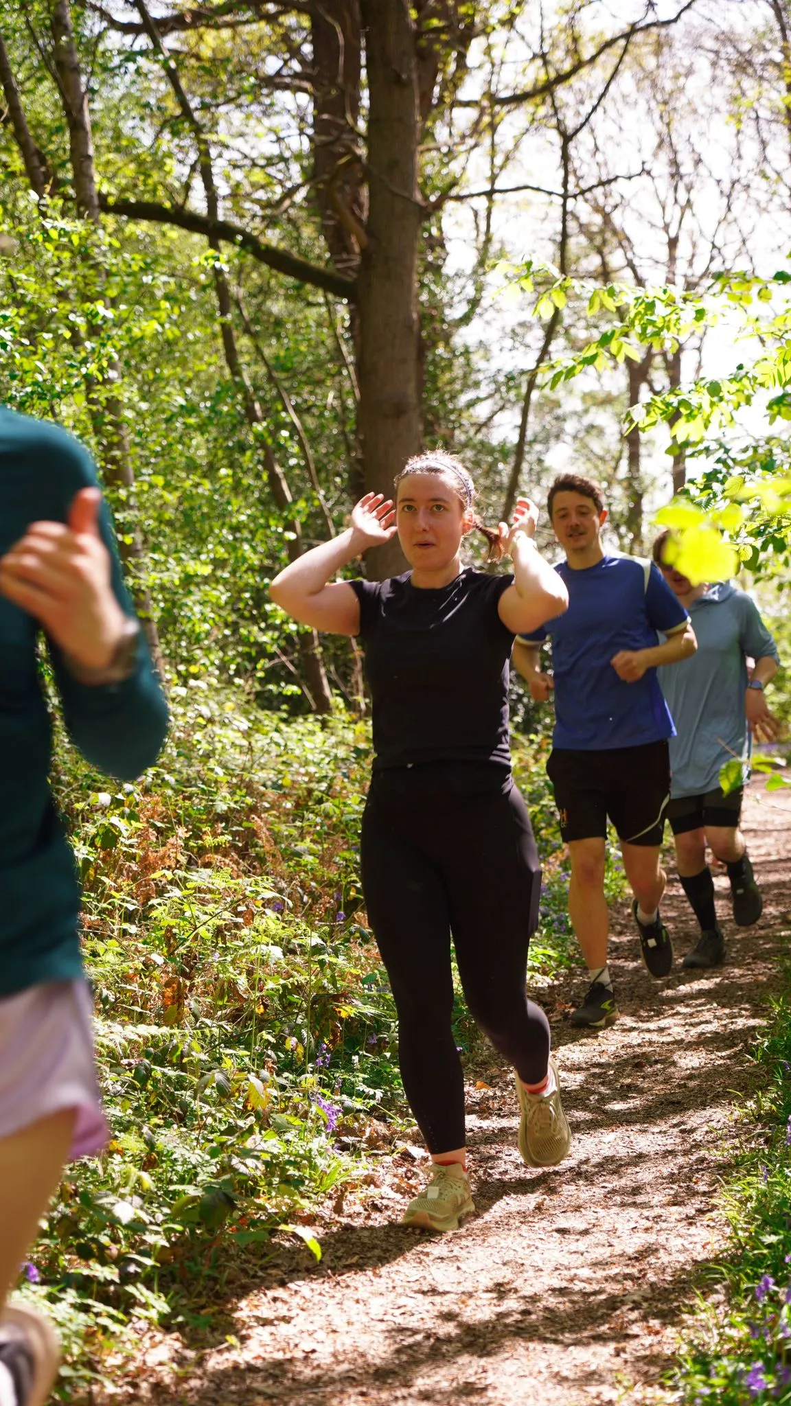A runner on the bluebell woodland trail at Backyard Egg