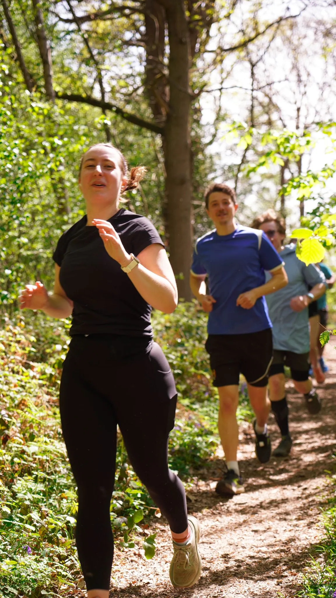 A runner on the bluebell woodland trail at Backyard Egg