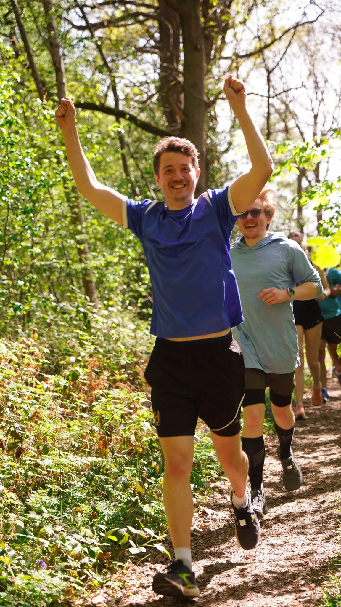 A runner on the bluebell woodland trail at Backyard Egg