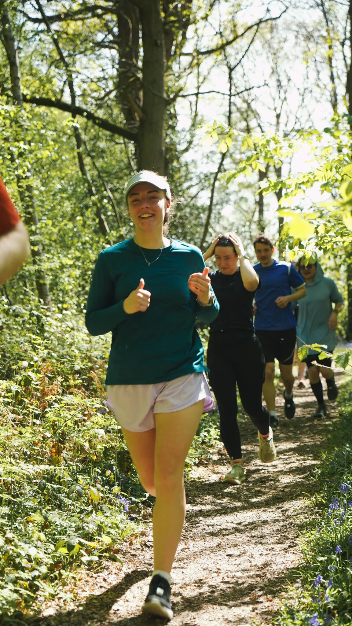 A runner on the bluebell woodland trail at Backyard Egg