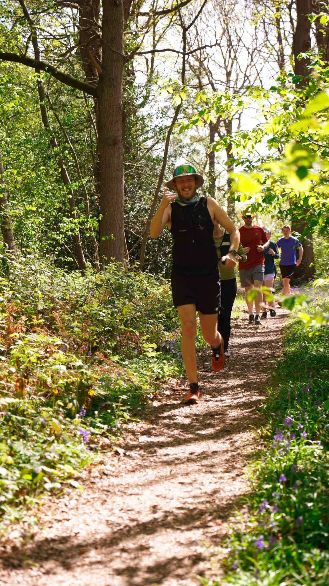 A runner on the bluebell woodland trail at Backyard Egg