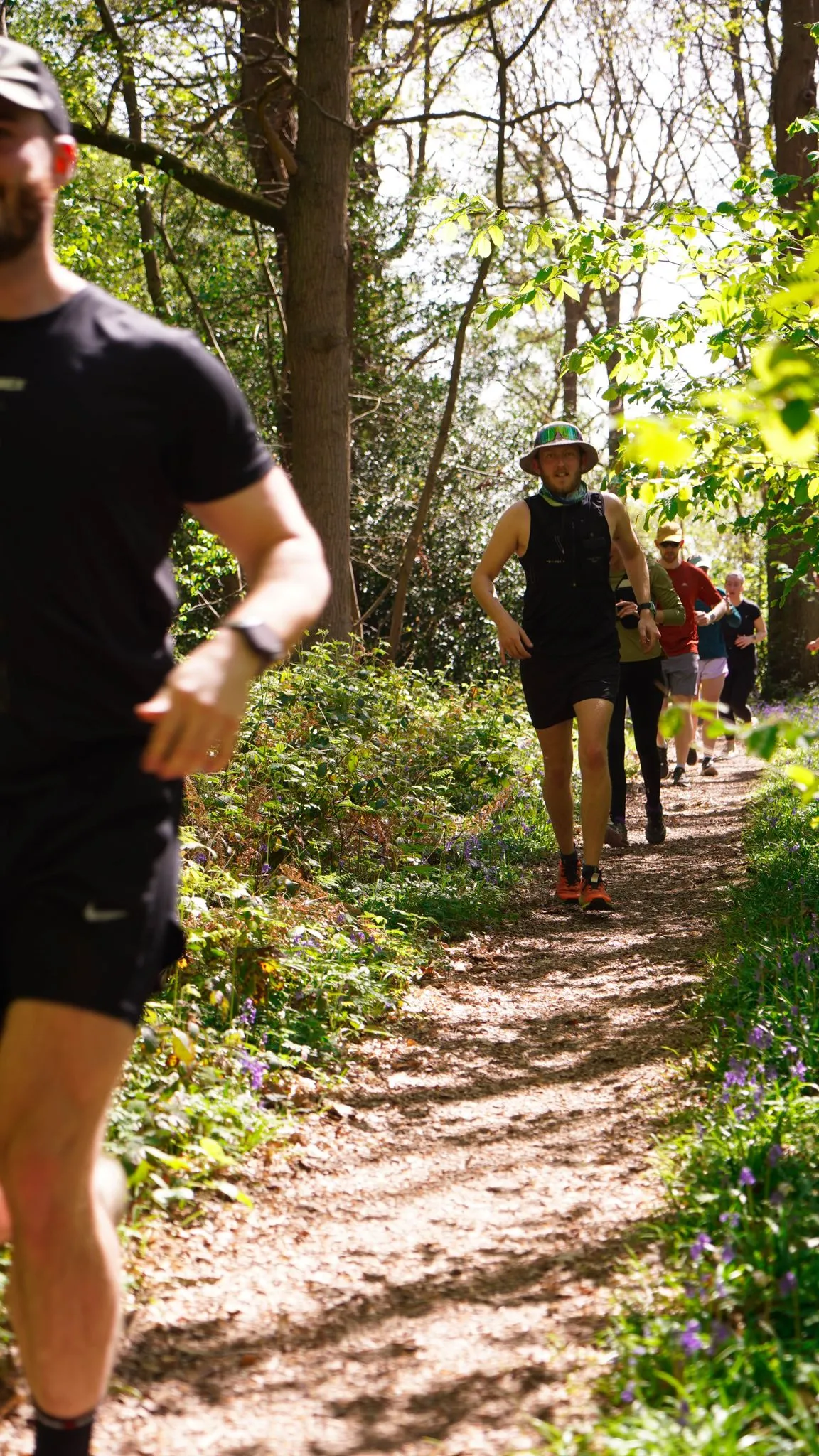 A runner on the bluebell woodland trail at Backyard Egg