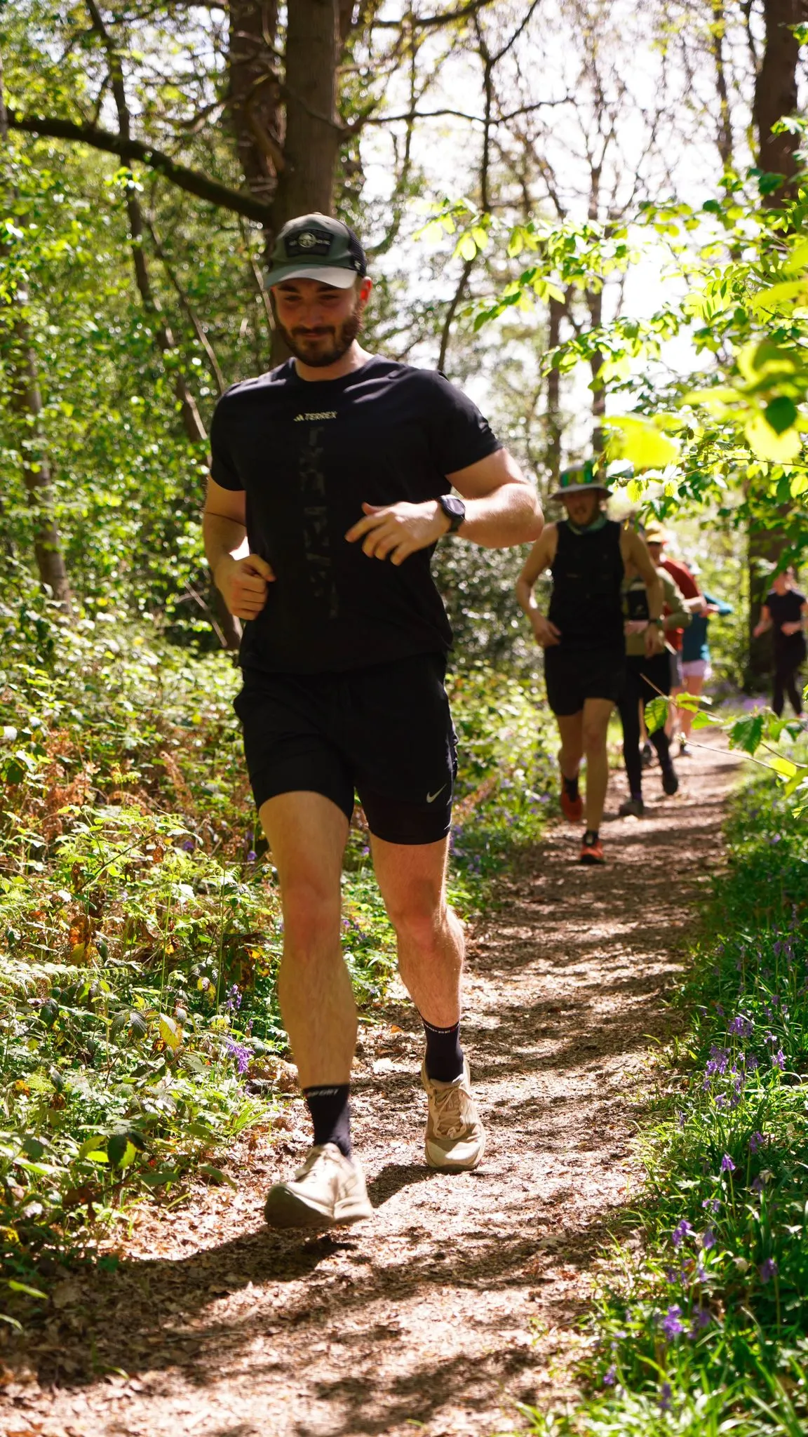 A runner on the bluebell woodland trail at Backyard Egg