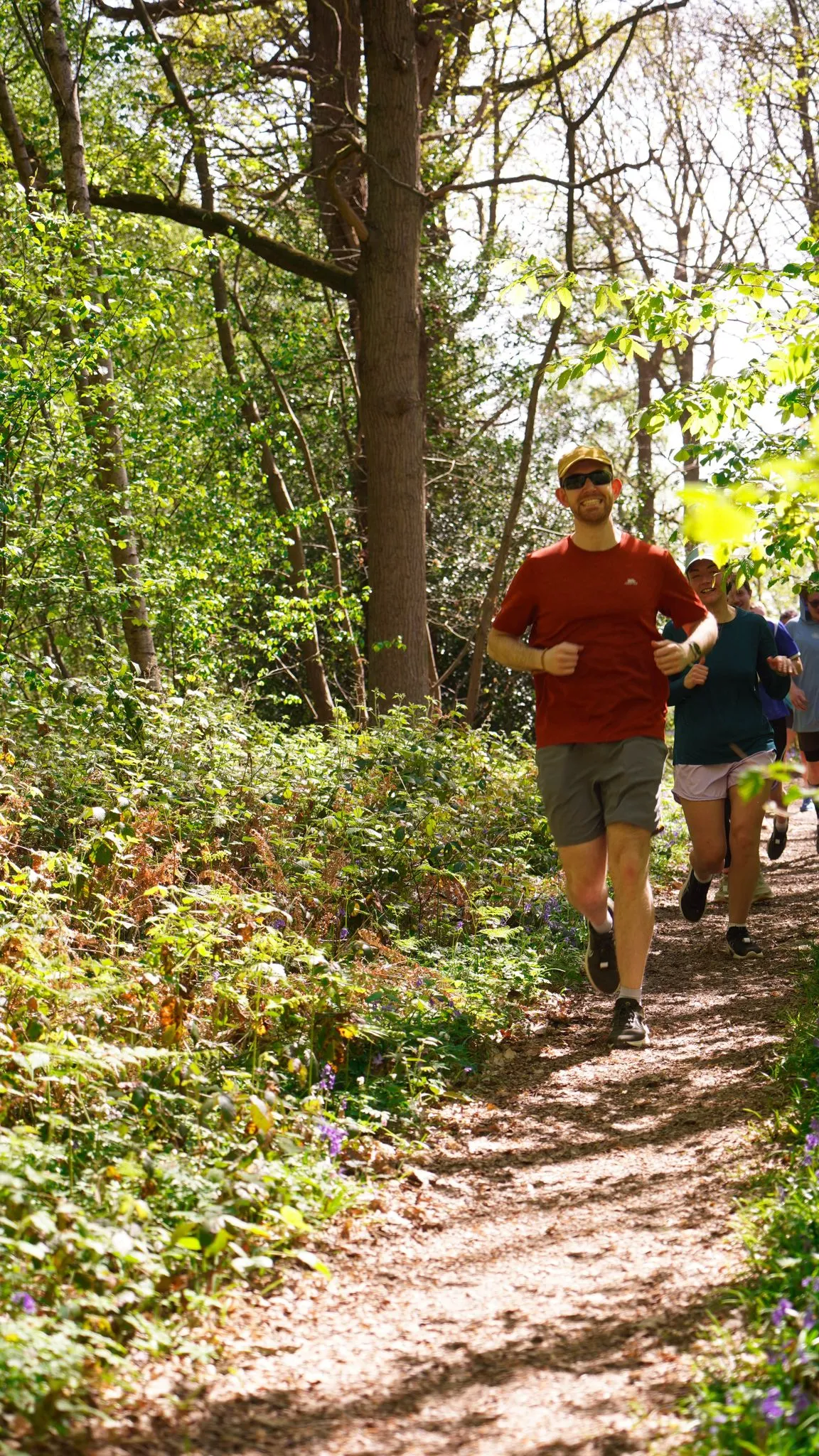 A runner on the bluebell woodland trail at Backyard Egg