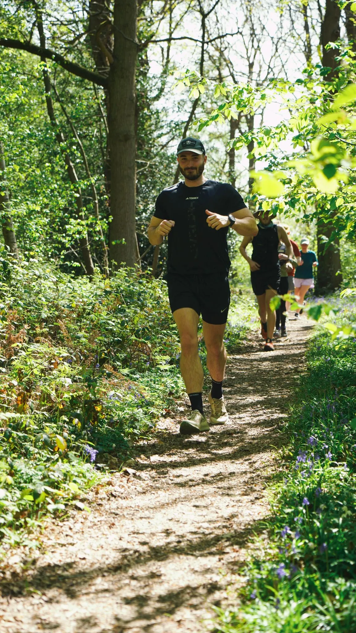 A runner on the bluebell woodland trail at Backyard Egg
