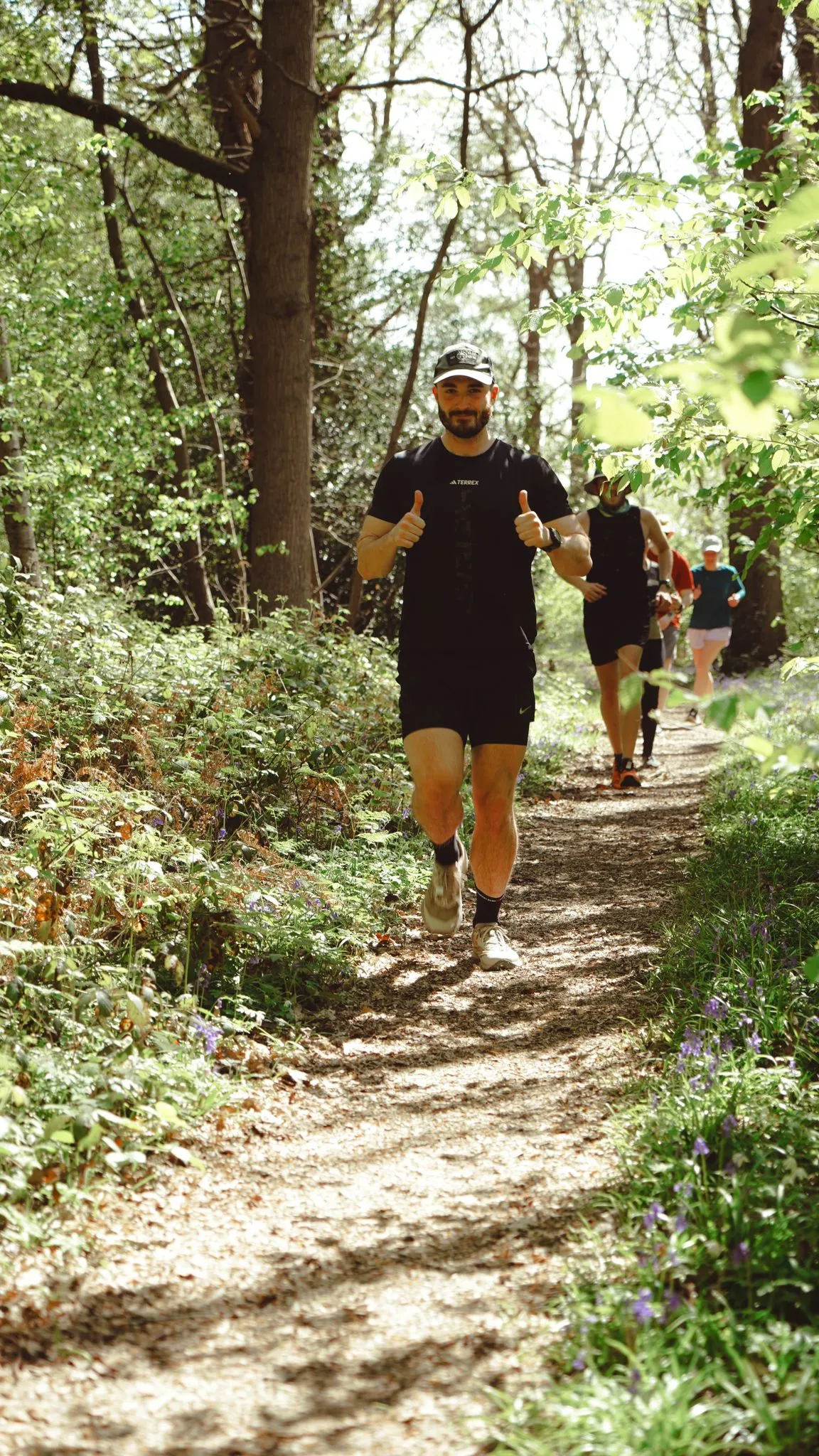 A runner on the bluebell woodland trail at Backyard Egg
