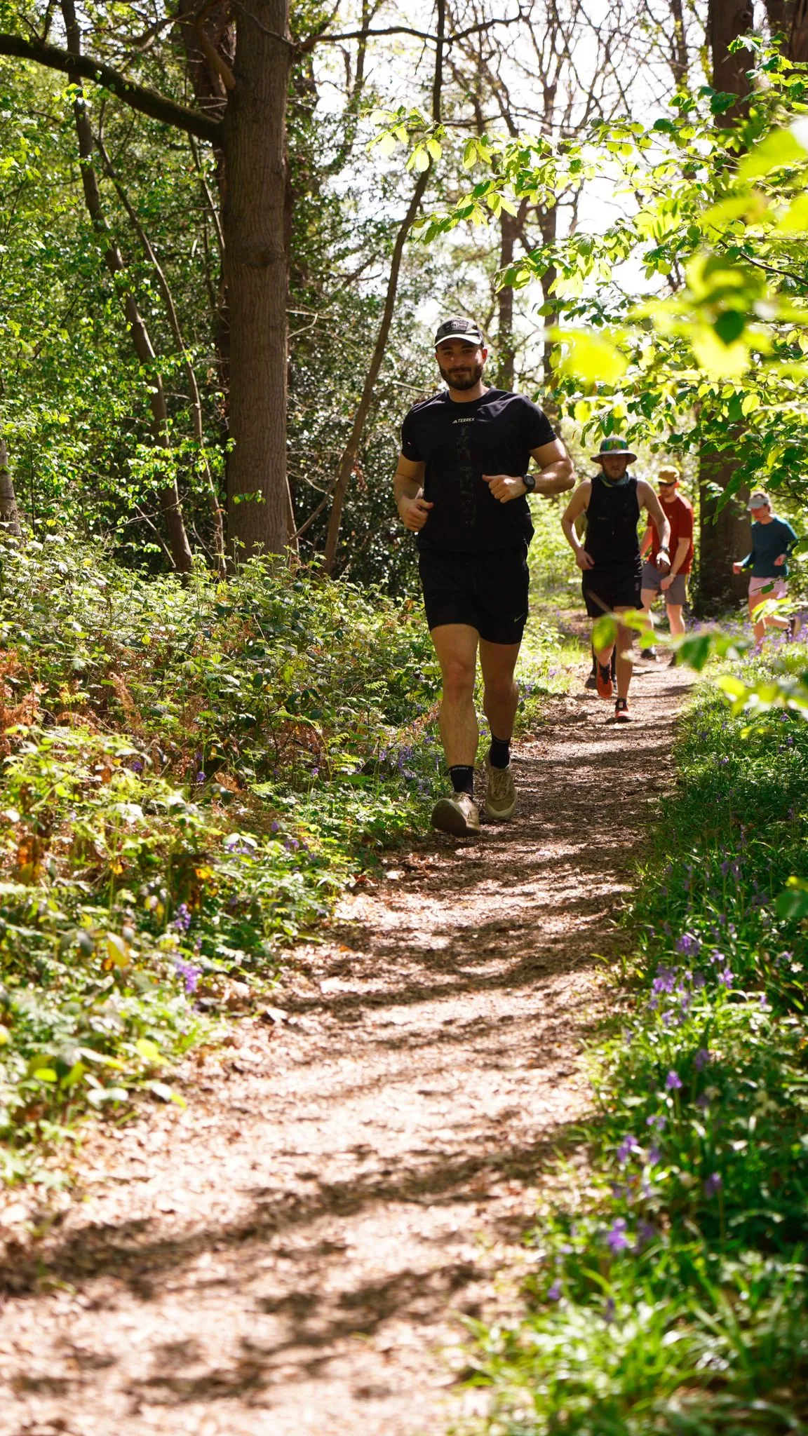 A runner on the bluebell woodland trail at Backyard Egg