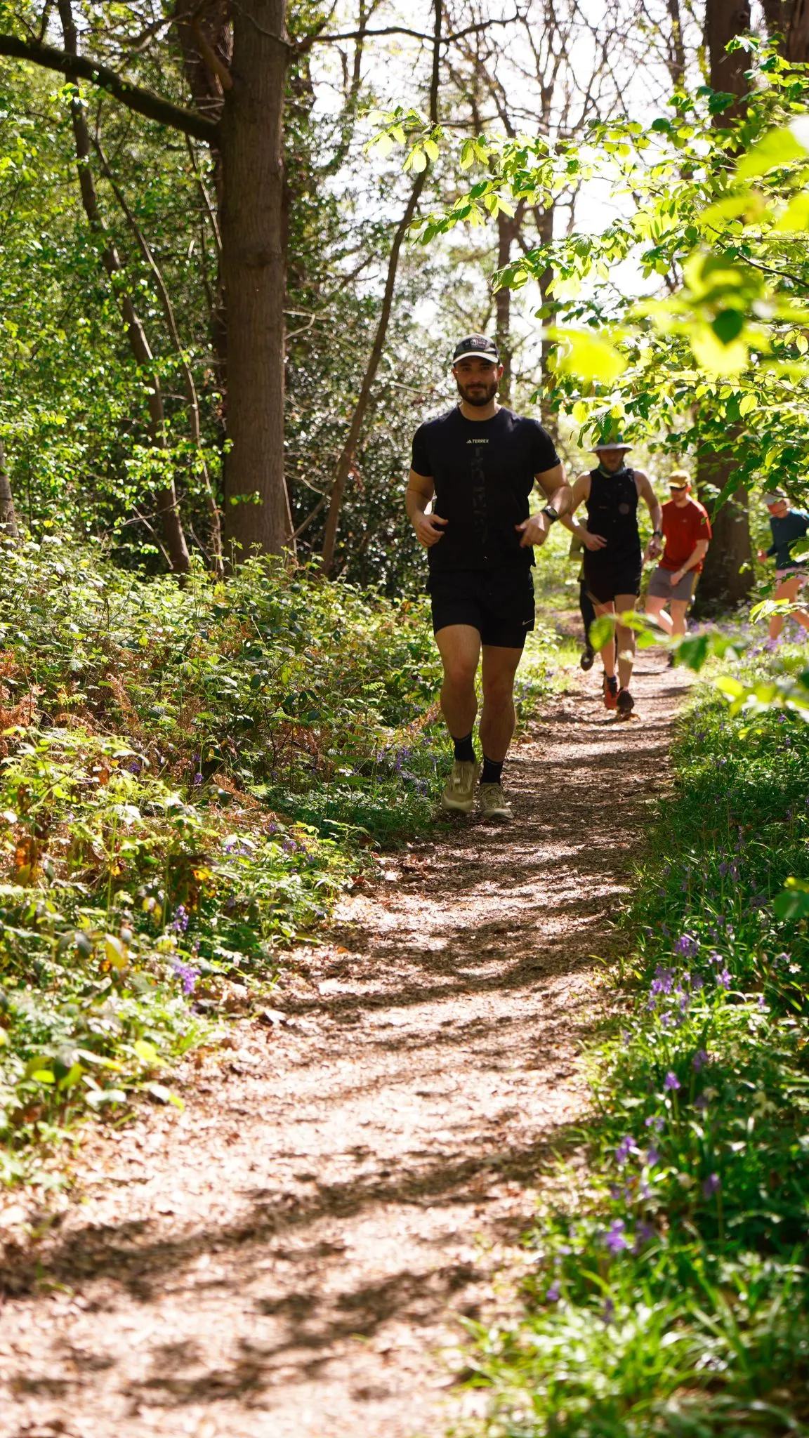 A runner on the bluebell woodland trail at Backyard Egg