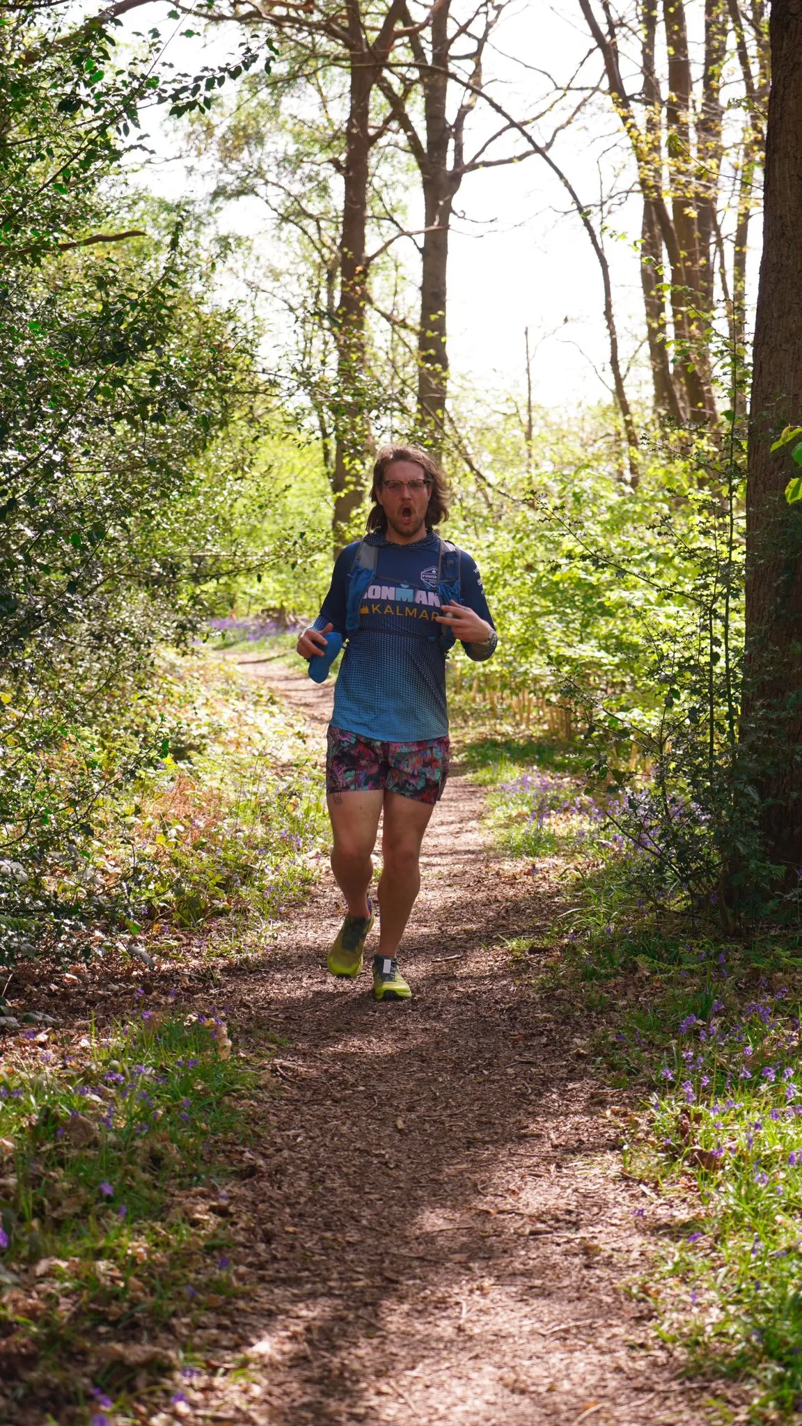 A runner on the bluebell woodland trail at Backyard Egg