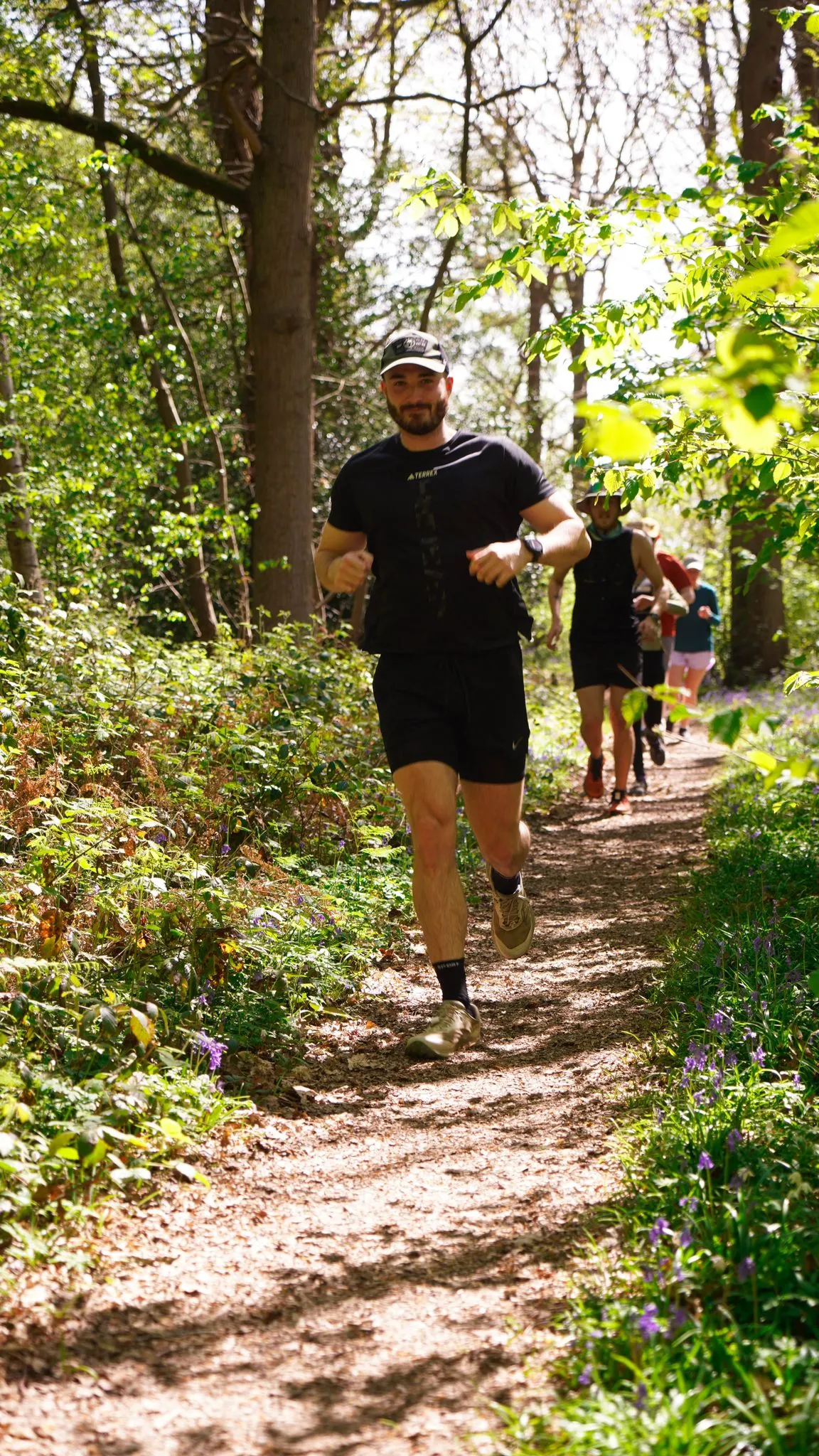A runner on the bluebell woodland trail at Backyard Egg