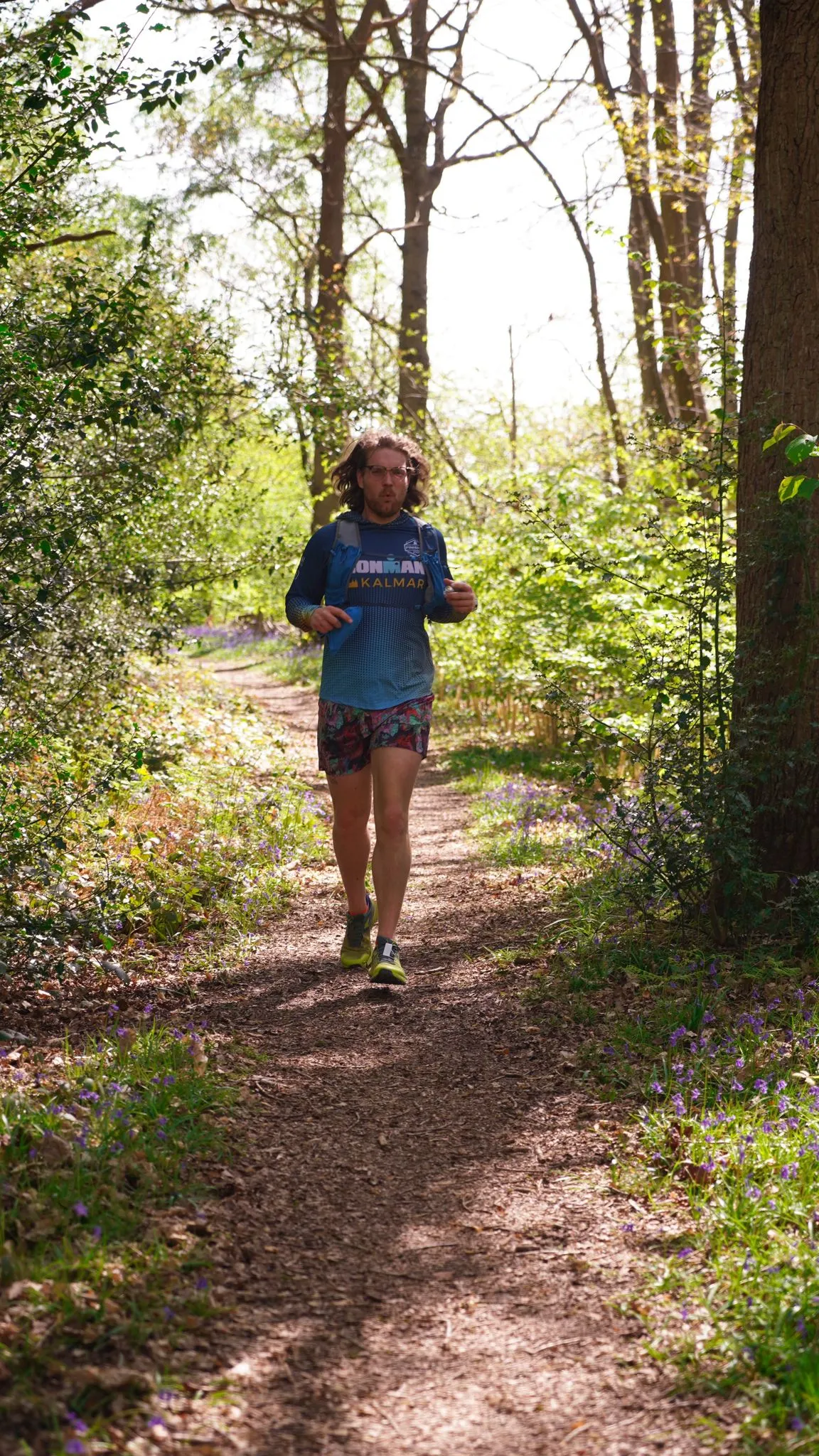 A runner on the bluebell woodland trail at Backyard Egg